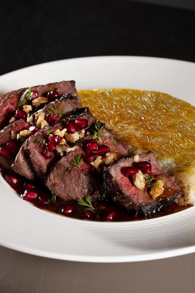 Perse Torsh Filet Chenjeh, featuring 6 pieces of fresh filet garnished with pomegranate seeds, herbs, and chopped walnuts.