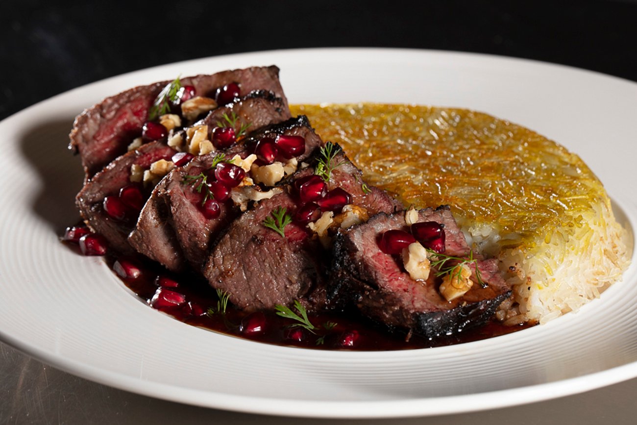 Perse Torsh Filet Chenjeh, featuring 6 pieces of fresh filet garnished with pomegranate seeds, herbs, and chopped walnuts.