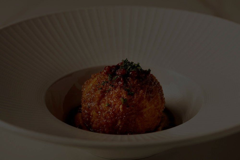 Perse's special Tahchin, served on a beautiful plate and garnished with barberry and herbs.