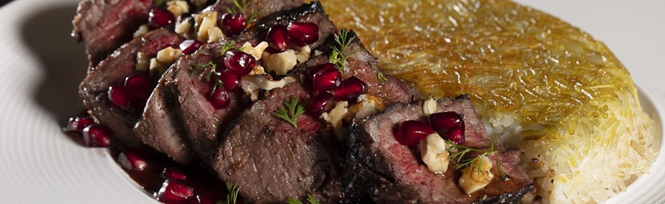 Perse Torsh Filet Chenjeh, featuring 6 pieces of fresh filet garnished with pomegranate seeds, herbs, and chopped walnuts.